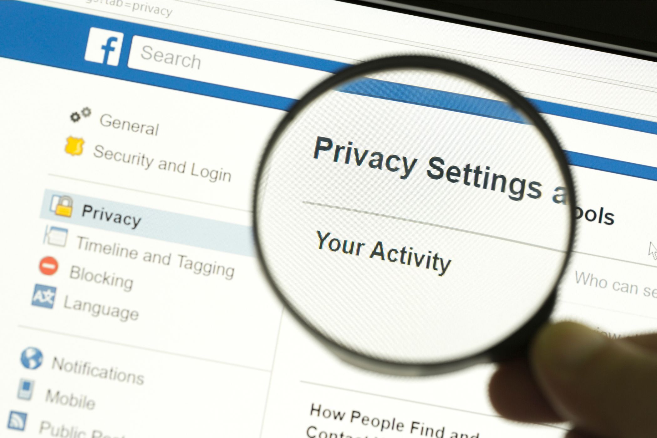 facebook privacy settings on a screen with a magnifying glass